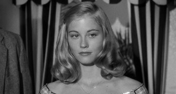 Movie still from “The Last Picture Show” (1971), directed by Peter Bogdanovich – A woman with long blonde hair wearing a checkered dress; Close Up shot, Low angle