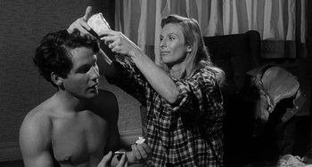 Movie still from “The Last Picture Show” (1971), directed by Peter Bogdanovich – A man and a woman are combing each other's hair; Close Up shot, Over the shoulder angle