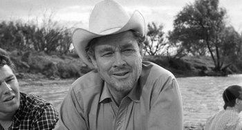 Movie still from “The Last Picture Show” (1971), directed by Peter Bogdanovich – A man wearing a cowboy hat sitting in the grass; Close Up shot, Low angle