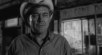 Movie still from “The Last Picture Show” (1971), directed by Peter Bogdanovich – A man wearing a cowboy hat in front of a window; Close Up shot, Low angle