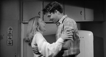 Movie still from “The Last Picture Show” (1971), directed by Peter Bogdanovich – A man and a woman are dancing in a kitchen; Medium shot, Low angle