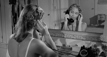 Movie still from “The Last Picture Show” (1971), directed by Peter Bogdanovich – A woman is looking at her reflection in the mirror; Close Up shot, High angle
