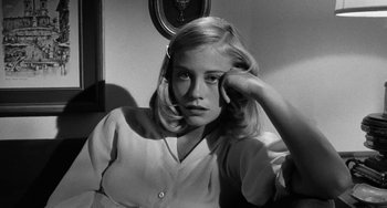 Movie still from “The Last Picture Show” (1971), directed by Peter Bogdanovich – A black - and - white photo of a young woman with her head resting on her hand; Close Up shot, High angle