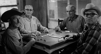 Movie still from “The Last Picture Show” (1971), directed by Peter Bogdanovich – A group of men sitting at a table playing dominoes; Medium shot, High angle