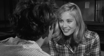 Movie still from “The Last Picture Show” (1971), directed by Peter Bogdanovich – A young man and a young woman are talking to each other; Close Up shot, Over the shoulder angle