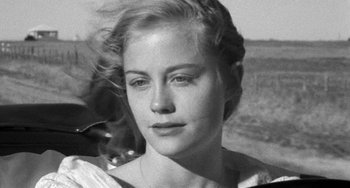 Movie still from “The Last Picture Show” (1971), directed by Peter Bogdanovich – A black - and - white photo of a woman in a field; Close Up shot, Over the shoulder angle
