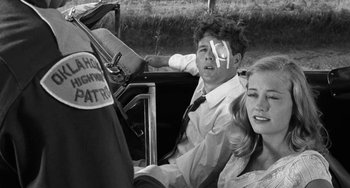 Movie still from “The Last Picture Show” (1971), directed by Peter Bogdanovich – A man and a woman sitting in the back of a car; Medium shot, Over the shoulder angle