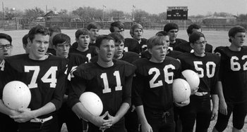 Movie still from “The Last Picture Show” (1971), directed by Peter Bogdanovich – A group of young men standing on top of a field; Medium shot, Low angle