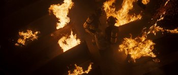 Movie still from “The Last Song” (2010), directed by Julie Anne Robinson – Two firemen standing next to each other in front of fire; Wide shot, High angle