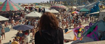 Movie still from “The Last Song” (2010), directed by Julie Anne Robinson – A crowd of people walking on a crowded beach; Wide shot, Over the shoulder angle