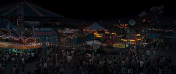 Movie still from “The Last Song” (2010), directed by Julie Anne Robinson – A crowd of people walking around a fair at night; Extreme Wide shot, High angle