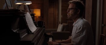 Movie still from “The Last Song” (2010), directed by Julie Anne Robinson – A man sitting in front of an open piano; Medium shot, Over the shoulder angle