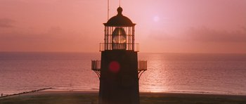 Movie still from “The Last Song” (2010), directed by Julie Anne Robinson – A light house on the beach at sunset; Extreme Wide shot, Low angle