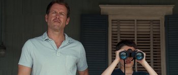 Movie still from “The Last Song” (2010), directed by Julie Anne Robinson – A man standing next to a woman holding a camera; Medium shot, Low angle