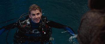 Movie still from “The Last Song” (2010), directed by Julie Anne Robinson – A man in a wet suit in the water; Medium shot, Over the shoulder angle