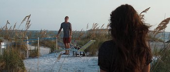 Movie still from “The Last Song” (2010), directed by Julie Anne Robinson – A man standing on the beach looking at a woman; Wide shot, Over the shoulder angle