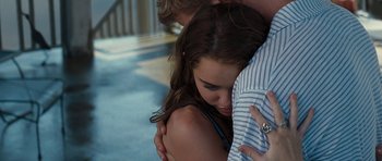Movie still from “The Last Song” (2010), directed by Julie Anne Robinson – A young woman hugging a young man while they both look sad; Medium shot, Over the shoulder angle