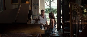 Movie still from “The Last Song” (2010), directed by Julie Anne Robinson – A man and a woman sitting at a piano in front of a window; Wide shot, Over the shoulder angle