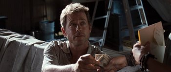 Movie still from “The Last Song” (2010), directed by Julie Anne Robinson – A person holding a stack of money; Close Up shot, Over the shoulder angle