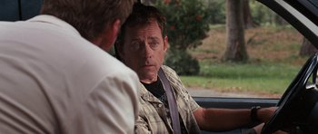 Movie still from “The Last Song” (2010), directed by Julie Anne Robinson – A man sitting in the back seat of a car talking to another man; Close Up shot, Over the shoulder angle