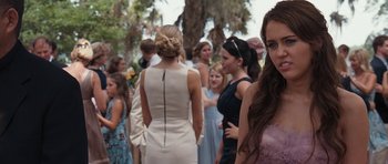 Movie still from “The Last Song” (2010), directed by Julie Anne Robinson – A group of people standing in a park; Close Up shot, Over the shoulder angle