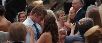 Movie still from “The Last Song” (2010), directed by Julie Anne Robinson – A man and a woman kissing in front of a group of people; Close Up shot, Over the shoulder angle