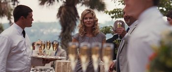 Movie still from “The Last Song” (2010), directed by Julie Anne Robinson – A woman standing in front of a group of champagne flutes; Medium shot, Over the shoulder angle