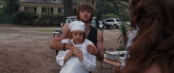 Movie still from “The Last Song” (2010), directed by Julie Anne Robinson – A man and a woman standing next to each other in front of a table; Medium shot, Over the shoulder angle