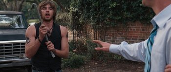 Movie still from “The Last Song” (2010), directed by Julie Anne Robinson – A man in a black shirt is talking to another man in a white dress shirt; Medium shot, Over the shoulder angle