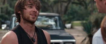 Movie still from “The Last Song” (2010), directed by Julie Anne Robinson – A person near a car on the street; Close Up shot, Over the shoulder angle