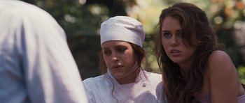 Movie still from “The Last Song” (2010), directed by Julie Anne Robinson – Two women wearing chef's uniforms and a white hat; Close Up shot, Over the shoulder angle