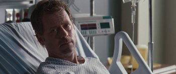 A person laying in a hospital bed