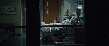 Movie still from “The Last Song” (2010), directed by Julie Anne Robinson – A man laying in a hospital bed next to a woman; Wide shot, Over the shoulder angle