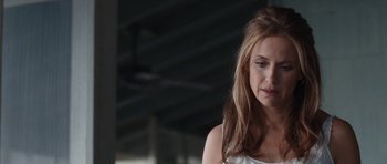 Movie still from “The Last Song” (2010), directed by Julie Anne Robinson – A beautiful young woman with long brown hair and wearing a white top; Close Up shot, Over the shoulder angle