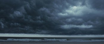 Movie still from “The Last Song” (2010), directed by Julie Anne Robinson – Dark clouds are rolling in over the ocean; Extreme Wide shot, Low angle