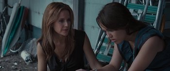 Movie still from “The Last Song” (2010), directed by Julie Anne Robinson – Two women sitting on a bench looking at a tablet; Close Up shot, Over the shoulder angle