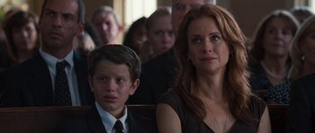 Movie still from “The Last Song” (2010), directed by Julie Anne Robinson – A woman sitting next to a young boy in front of other people; Close Up shot, Over the shoulder angle