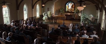 Movie still from “The Last Song” (2010), directed by Julie Anne Robinson – People sitting in a church with a piano in front of them; Extreme Wide shot, High angle