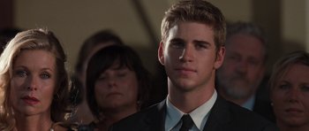 Movie still from “The Last Song” (2010), directed by Julie Anne Robinson – A man in a black suit and a woman in a black suit; Close Up shot, Over the shoulder angle