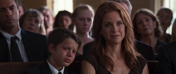Movie still from “The Last Song” (2010), directed by Julie Anne Robinson – A woman and a boy in front of other people; Close Up shot, Over the shoulder angle