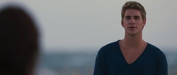 Movie still from “The Last Song” (2010), directed by Julie Anne Robinson – A man in a blue shirt is looking at the camera; Close Up shot, Over the shoulder angle
