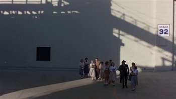 Movie still from “The Last Tycoon” (1976), directed by Elia Kazan – A group of people standing on the side of a building; Extreme Wide shot, High angle