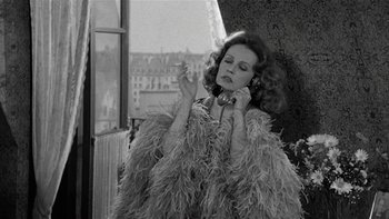 Movie still from “The Last Tycoon” (1976), directed by Elia Kazan – A black and white photo of a woman talking on a phone; Medium shot, High angle