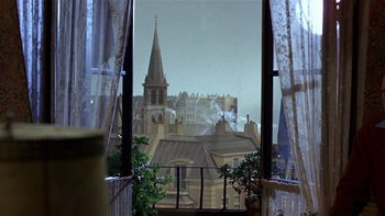 Movie still from “The Last Tycoon” (1976), directed by Elia Kazan – A view of a church from an open window; Wide shot, High angle