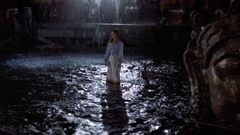 Movie still from “The Last Tycoon” (1976), directed by Elia Kazan – A woman standing in the water in the rain; Wide shot, High angle