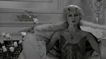 Movie still from “The Last Tycoon” (1976), directed by Elia Kazan – A black and white photo of a woman in a dress; Medium shot, Low angle