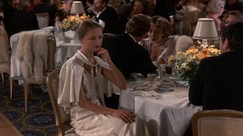 Movie still from “The Last Tycoon” (1976), directed by Elia Kazan – A group of people sitting at a dinner table; Medium shot, Over the shoulder angle
