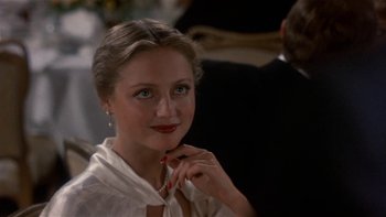 Movie still from “The Last Tycoon” (1976), directed by Elia Kazan – A beautiful woman with red lipstick posing for a picture; Close Up shot, Over the shoulder angle
