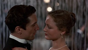 Movie still from “The Last Tycoon” (1976), directed by Elia Kazan – A man and a woman in formal wear looking at each other; Close Up shot, Low angle