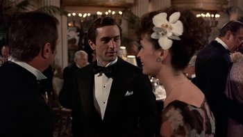 Movie still from “The Last Tycoon” (1976), directed by Elia Kazan – A man and a woman talking to each other in formal wear; Medium shot, Over the shoulder angle